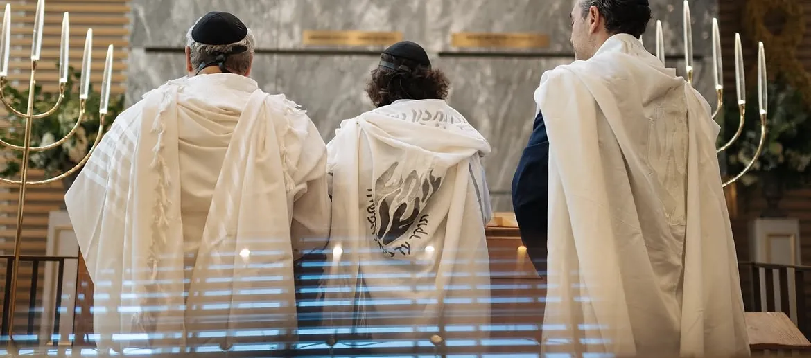 Trois générations en talit, de dos, lors d'une bar mitzvah à Paris